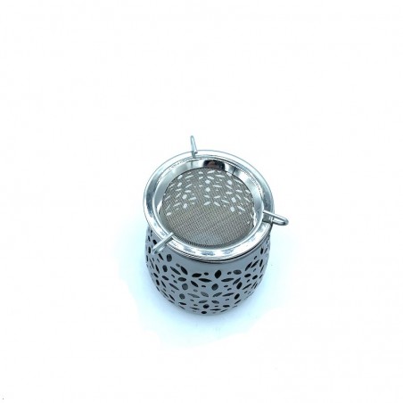 Metal incense burner with candle.