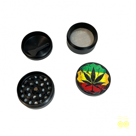 Rasta grinder with metal cannabis leaf and pollen catcher.